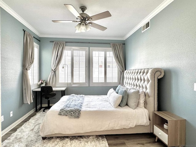 bedroom with ceiling fan, hardwood / wood-style floors, and ornamental molding