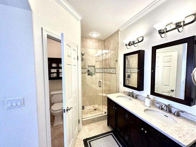 bathroom with toilet, ornamental molding, tile patterned floors, and a shower with shower door