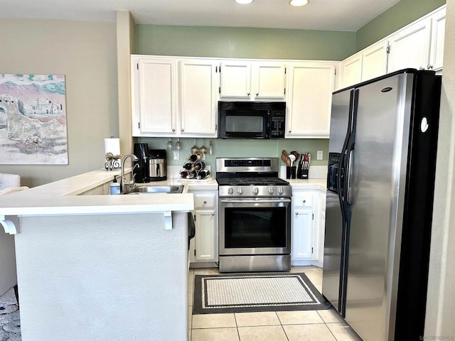 kitchen with light tile patterned floors, white cabinetry, kitchen peninsula, appliances with stainless steel finishes, and sink