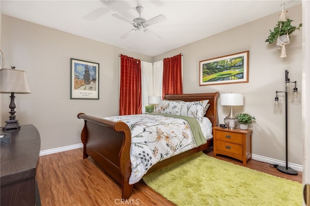 bedroom with ceiling fan and hardwood / wood-style flooring