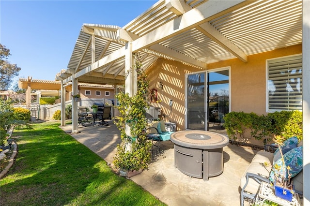 view of patio / terrace with an outdoor fire pit and a pergola