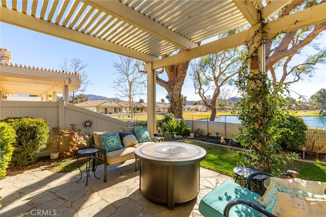 view of patio with a water view, an outdoor fire pit, and a pergola