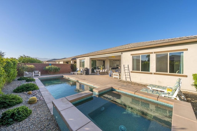 view of pool with an in ground hot tub and a patio area