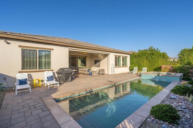 rear view of property featuring a pool with hot tub and a patio