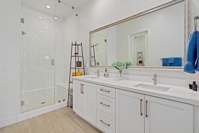 bathroom featuring vanity, hardwood / wood-style flooring, and an enclosed shower