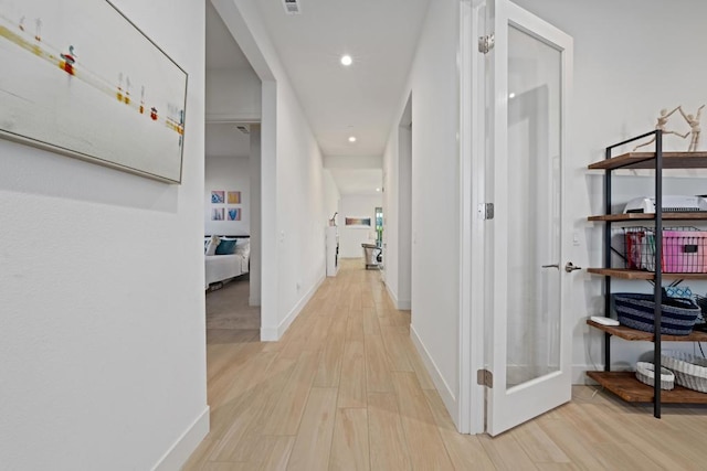 corridor featuring light hardwood / wood-style flooring