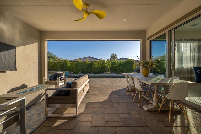 view of patio / terrace with a fire pit and ceiling fan