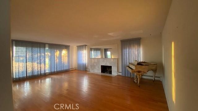 unfurnished living room with hardwood / wood-style flooring and a fireplace