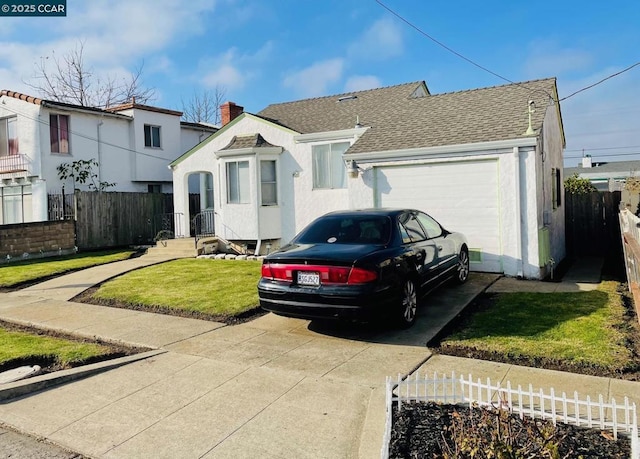 view of front of home featuring a garage and a front yard