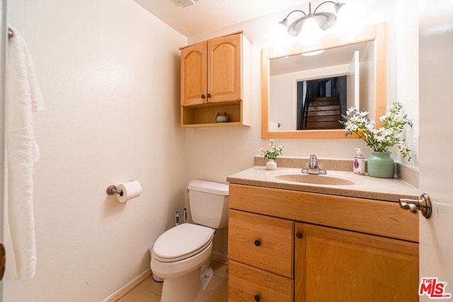 bathroom featuring toilet and vanity