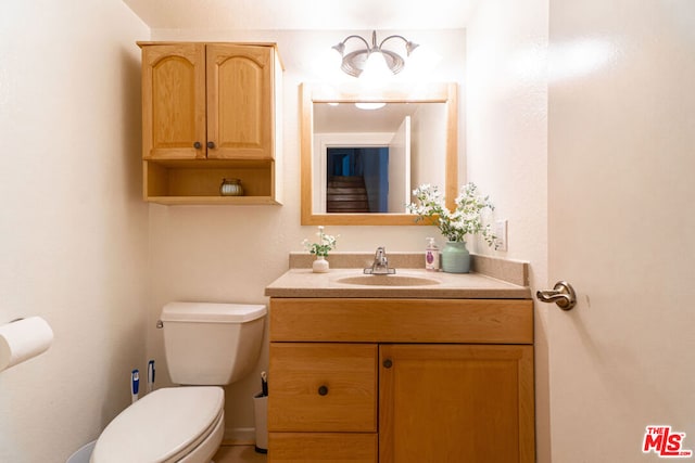 bathroom featuring toilet and vanity