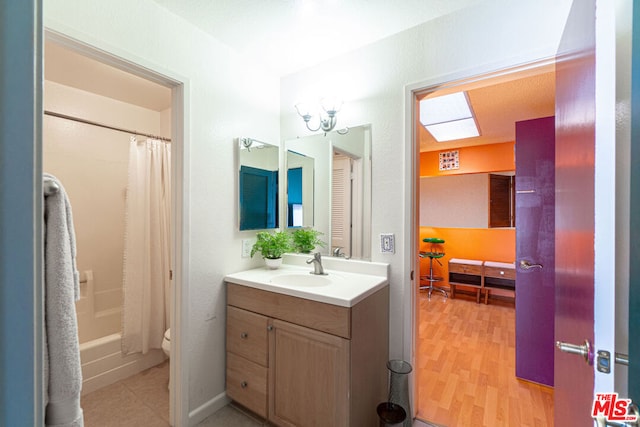 full bathroom with hardwood / wood-style floors, toilet, vanity, and shower / bathtub combination with curtain