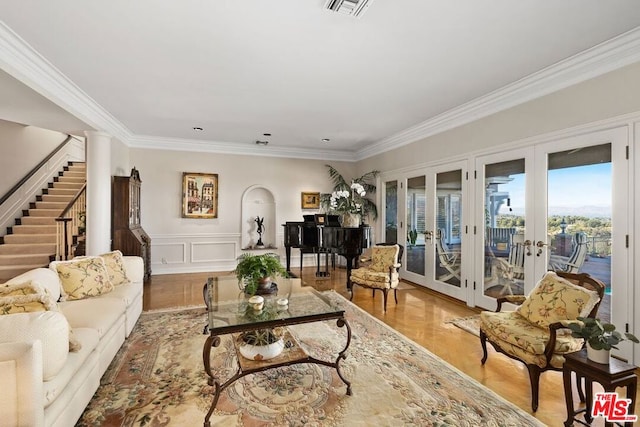 living room featuring crown molding and french doors