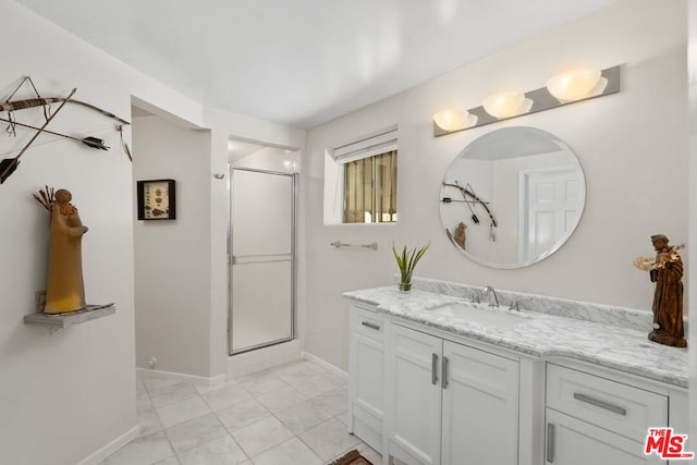 bathroom featuring vanity and a shower with door