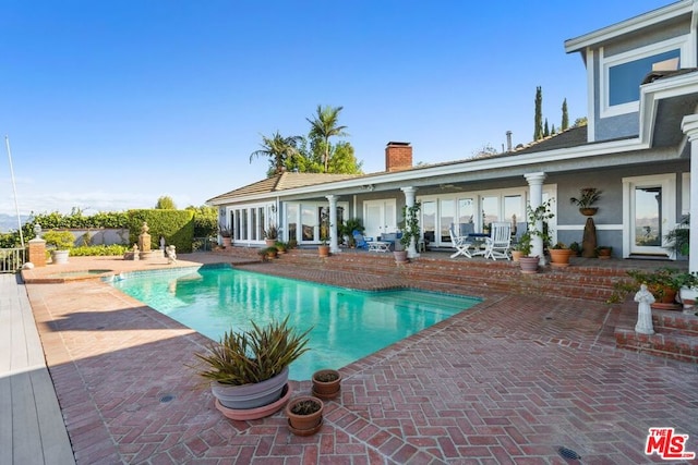 view of swimming pool with a patio area