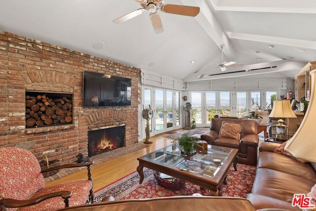 living room featuring a brick fireplace, a healthy amount of sunlight, french doors, and ceiling fan