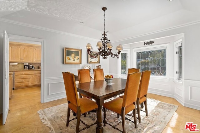 dining space featuring light parquet floors, a chandelier, and crown molding