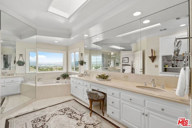 bathroom with vanity, crown molding, and tiled tub