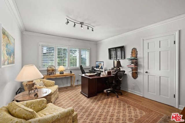 office featuring rail lighting, ornamental molding, and light wood-type flooring