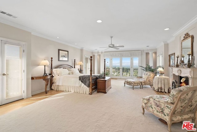 carpeted bedroom with ceiling fan, crown molding, decorative columns, and access to outside