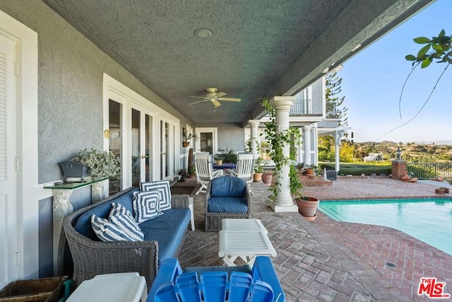 view of patio / terrace featuring ceiling fan, a fenced in pool, and an outdoor hangout area