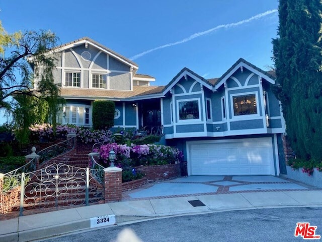 tudor-style house featuring a garage