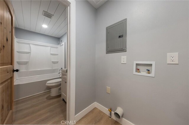 laundry area featuring wood-type flooring, electric panel, gas dryer hookup, and hookup for a washing machine