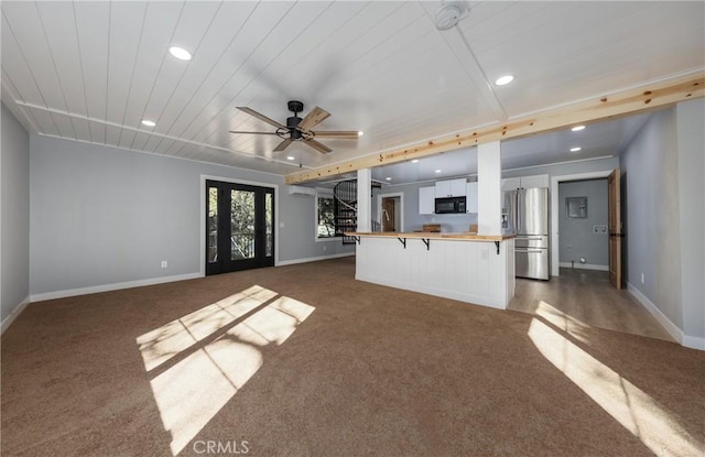 kitchen featuring wood counters, white cabinetry, dark colored carpet, a kitchen breakfast bar, and stainless steel fridge with ice dispenser