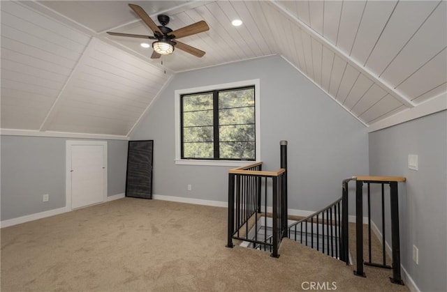 additional living space featuring ceiling fan, light colored carpet, and vaulted ceiling