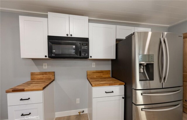 kitchen featuring light hardwood / wood-style floors, white cabinetry, and stainless steel fridge with ice dispenser