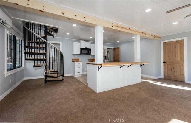 kitchen with wood counters, a kitchen bar, white cabinetry, stainless steel fridge with ice dispenser, and dark carpet