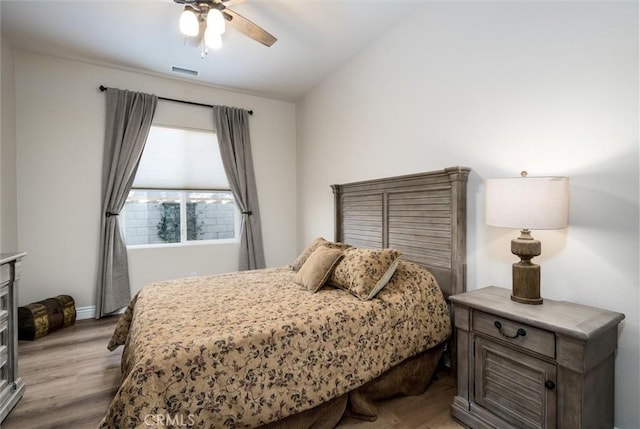 bedroom with light hardwood / wood-style floors and ceiling fan