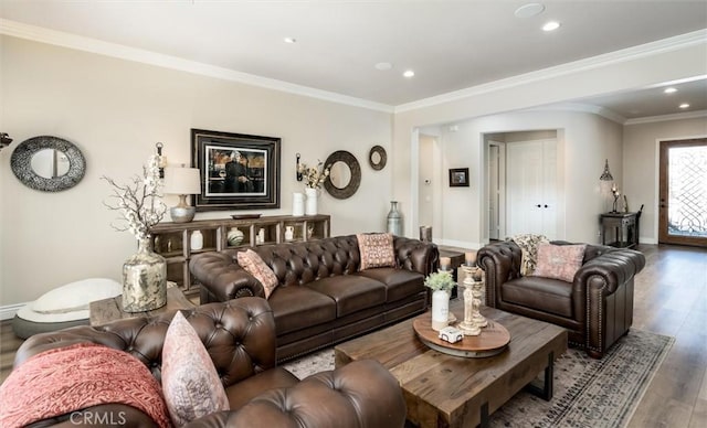 living room featuring hardwood / wood-style floors and crown molding