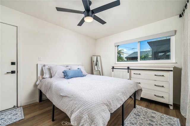 bedroom with ceiling fan and dark hardwood / wood-style floors