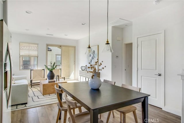 dining area with hardwood / wood-style floors