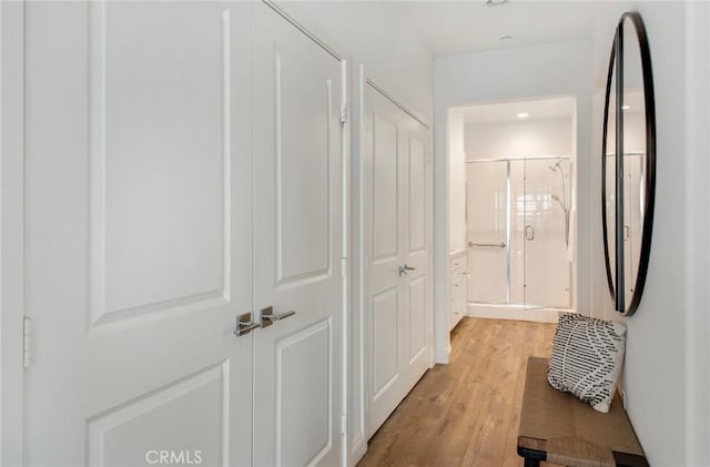 hallway with light hardwood / wood-style flooring