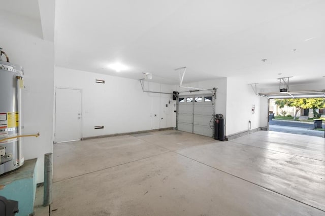 garage with a garage door opener and strapped water heater