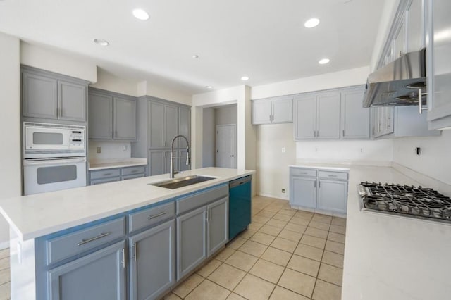 kitchen featuring light tile patterned floors, an island with sink, ventilation hood, appliances with stainless steel finishes, and sink