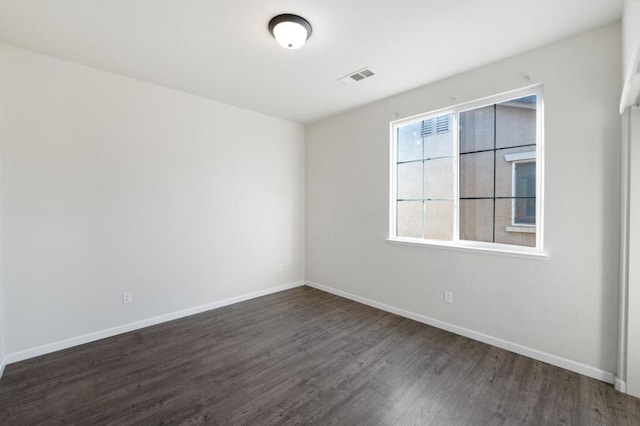 empty room with dark wood-type flooring