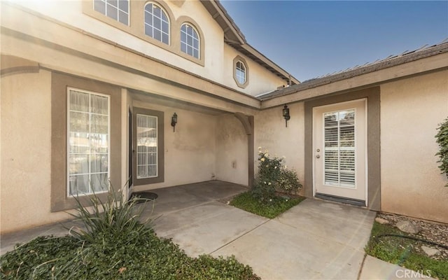 property entrance featuring a patio