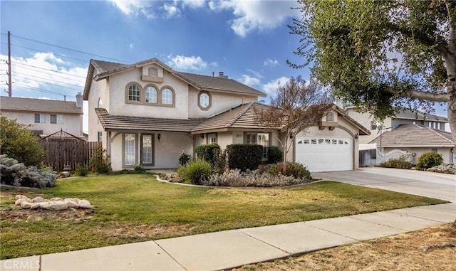 view of property featuring a garage and a front yard