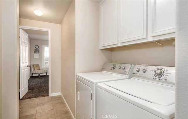 laundry area featuring cabinets, light tile patterned floors, and independent washer and dryer