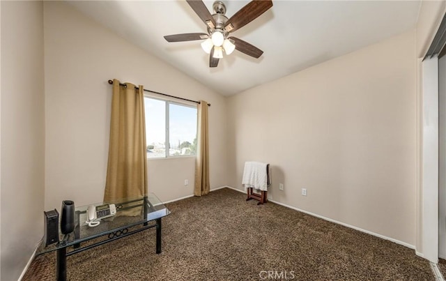 interior space featuring ceiling fan, lofted ceiling, and dark colored carpet