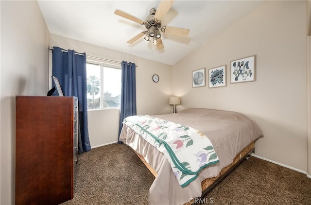 bedroom with ceiling fan, dark carpet, and lofted ceiling