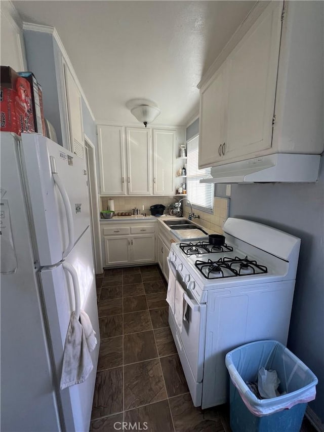 kitchen featuring white cabinetry, sink, white appliances, and tasteful backsplash