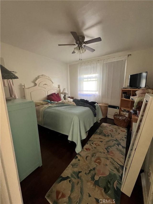 bedroom featuring dark hardwood / wood-style flooring and ceiling fan