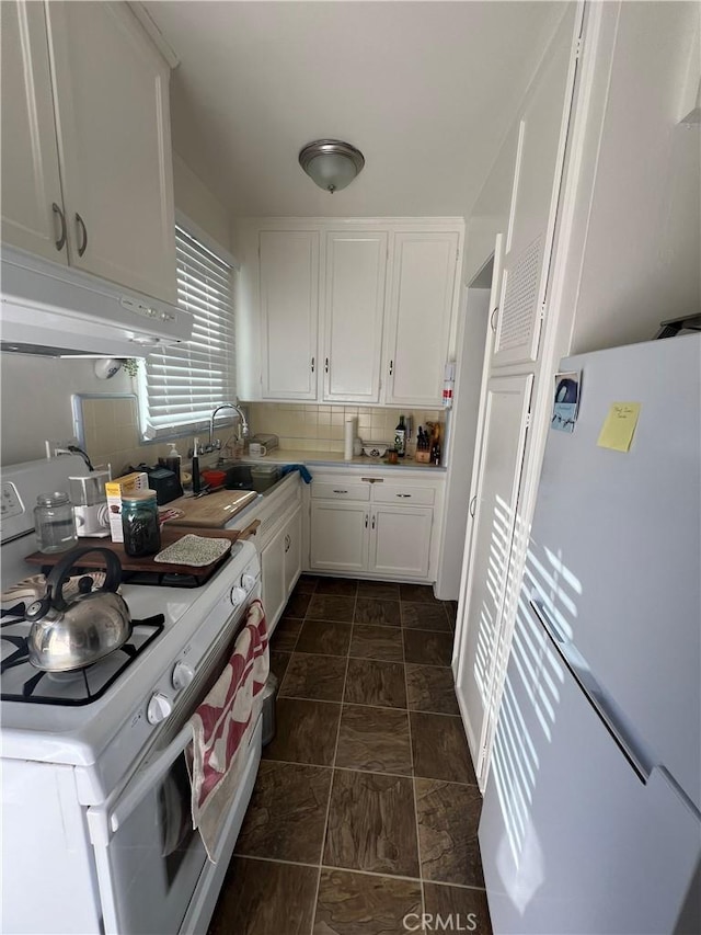 kitchen featuring white cabinetry, white appliances, sink, and tasteful backsplash