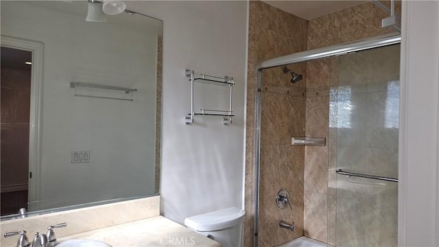 full bathroom with enclosed tub / shower combo, toilet, and vanity