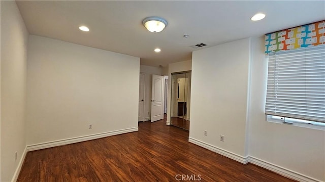 unfurnished room featuring dark hardwood / wood-style flooring