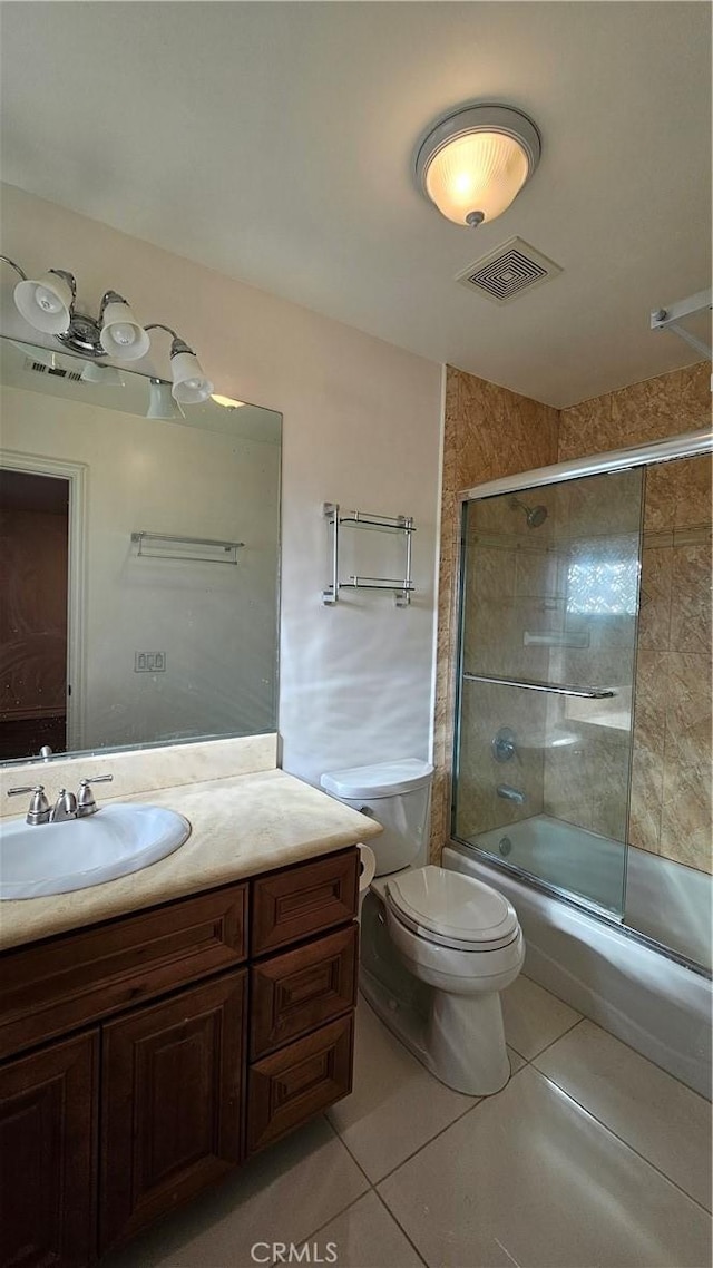 full bathroom with toilet, tile patterned flooring, vanity, and shower / bath combination with glass door